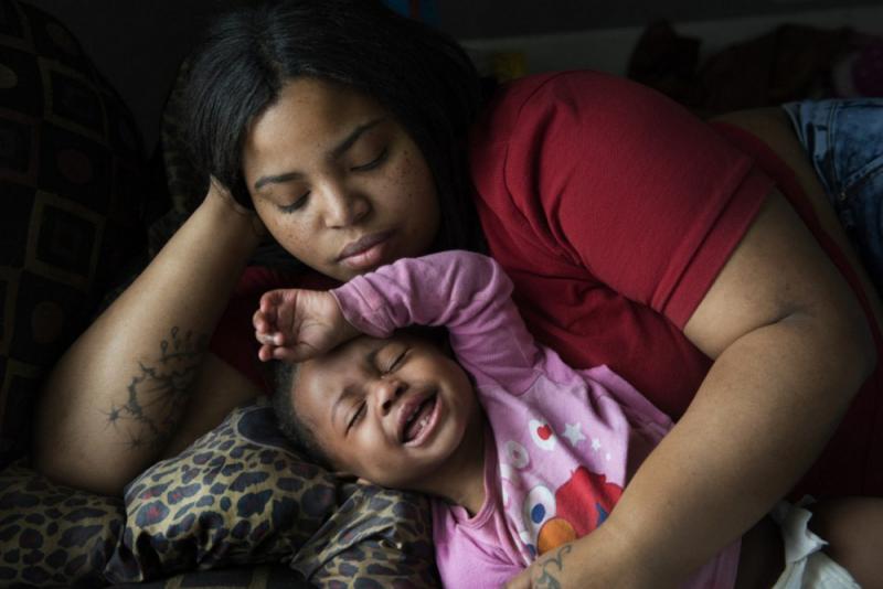 Nakeyja Cade with her year-old daughter Zariyah Cade in Flint, Mich., last March. The girl's blood had tested high for lead. A new study shows children with elevated blood-lead levels at age 11 ended up as adults with lower cognitive function than their parents. Washington Post photo by Linda Davidson